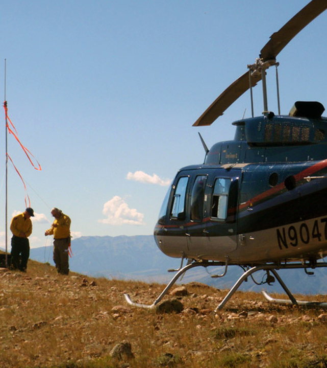 helicopter parked atop a mountain